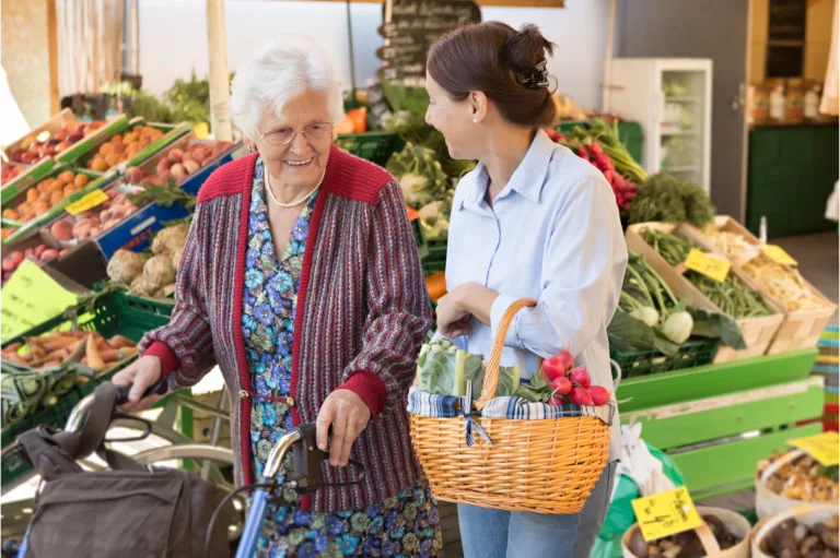 care worker assisting elderly women in shopping