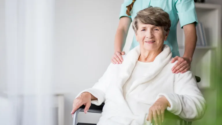 a happy old women in a wheelchair