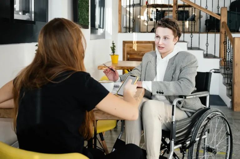 a disabled youth talking to care worker